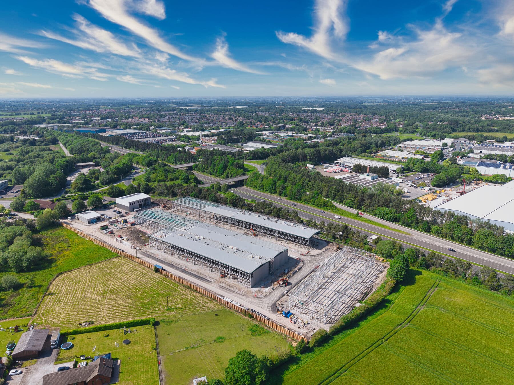 Top-down aerial with Skelmersdale and the West Lancashire plain in the distance