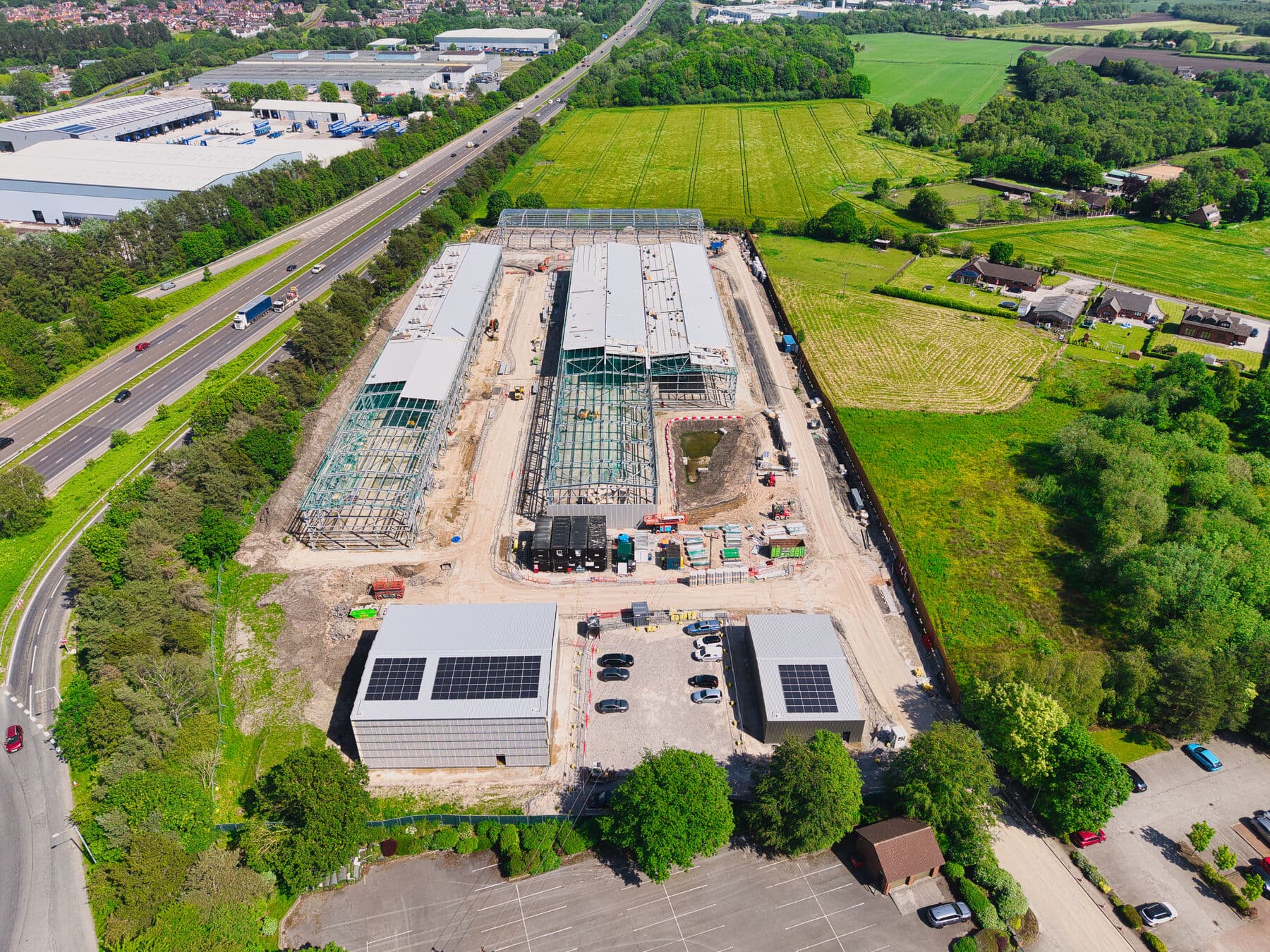 South-side aerial showing the completed units, solar installations and the access road